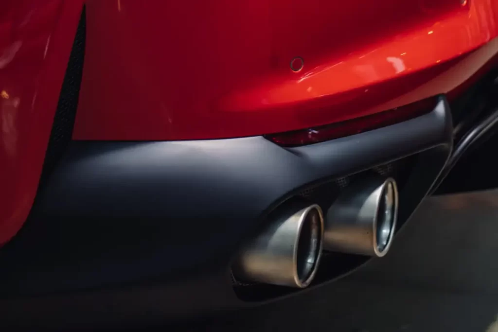 Red car exhaust tailpipe.
