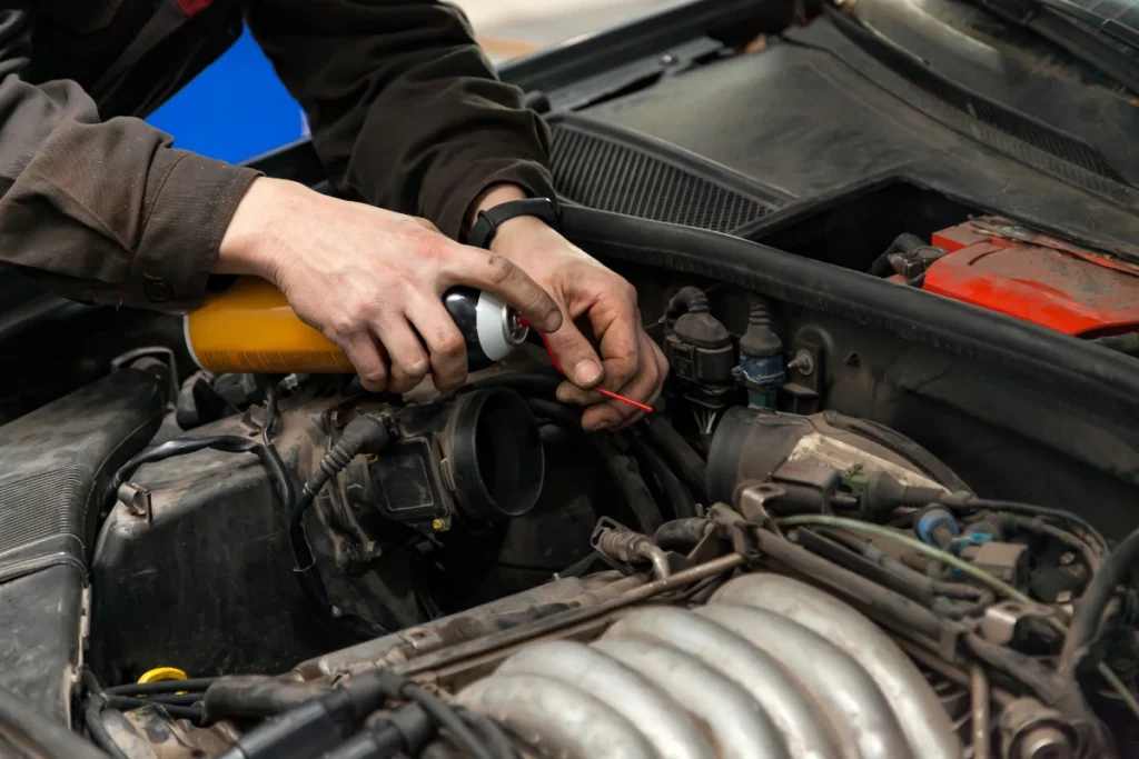 Car exhaust manifold bolt sprayed with loctite or anti-seize