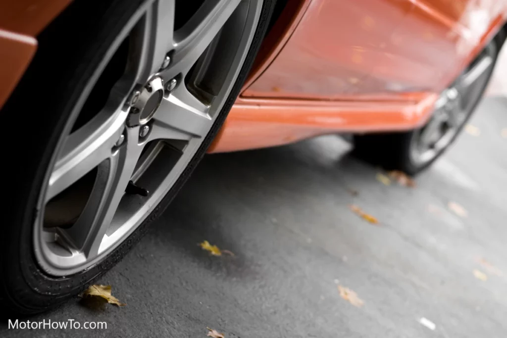 Red car with alloy wheels and tire