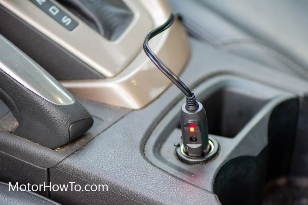 Car battery charging via cigarette lighter socket connected to a solar panel