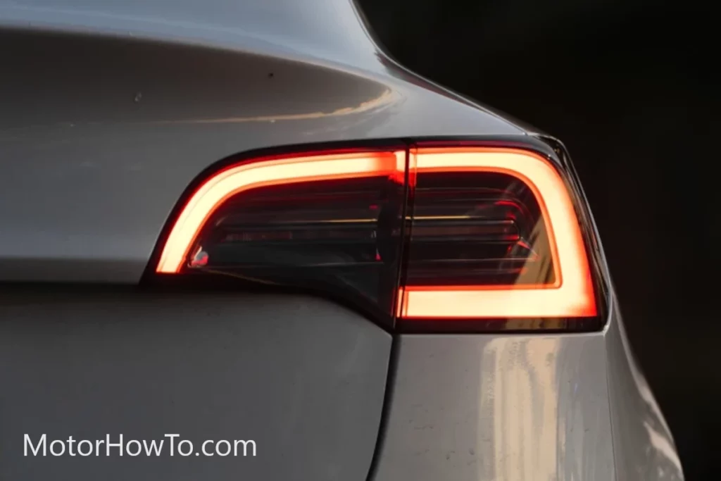 White EV rear brake lights on during regenerative braking.