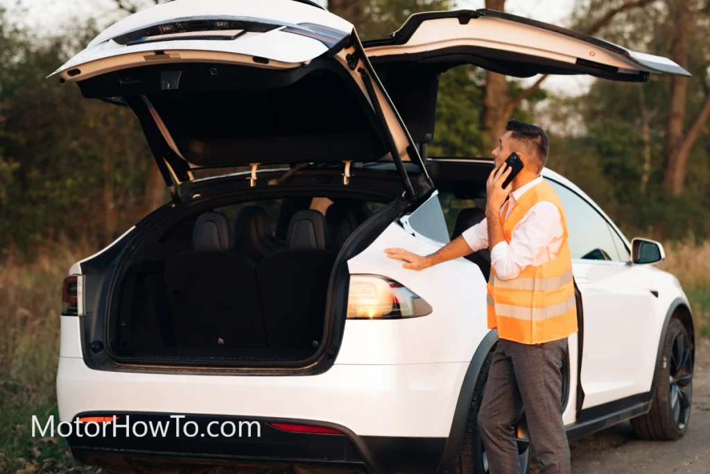 Ran out of miles and broken down white Tesla electric car EV along the roadside