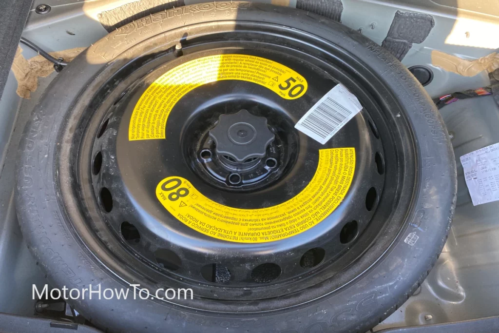 Spare wheel or donut tire in boot of the car