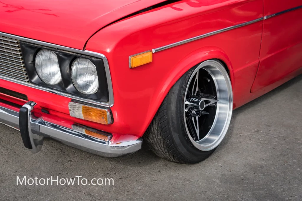 Red car wheels tilted inwards with steel rim