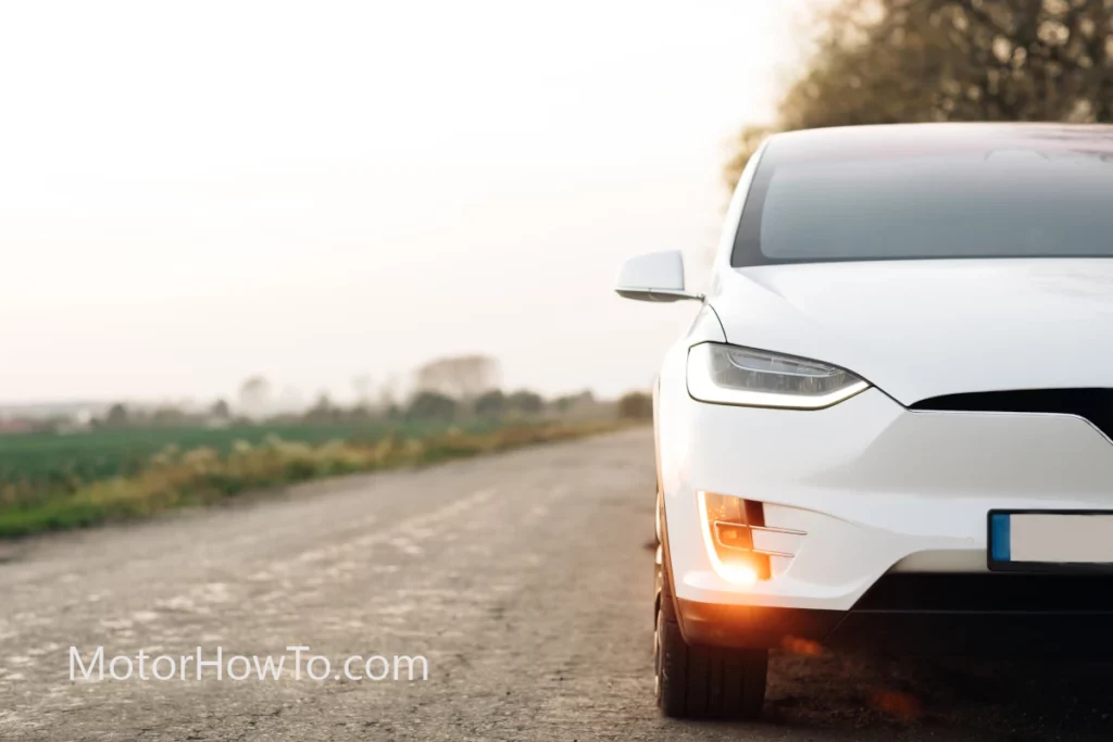 Stalled white electric car on a countryside road