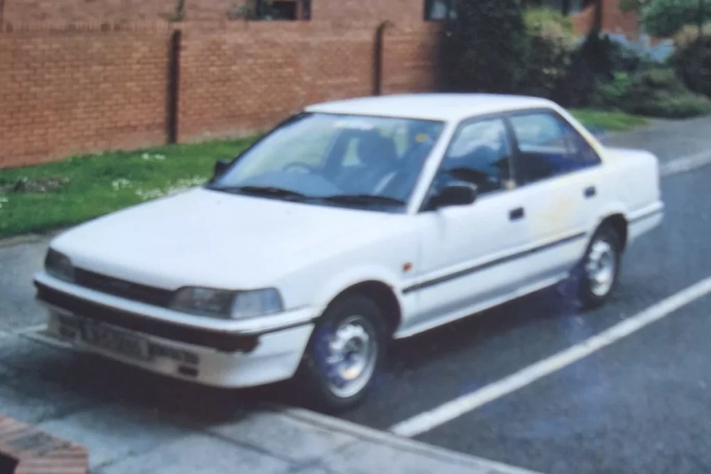 John Mailum's first car - Toyota corolla saloon petrol white from 80s model