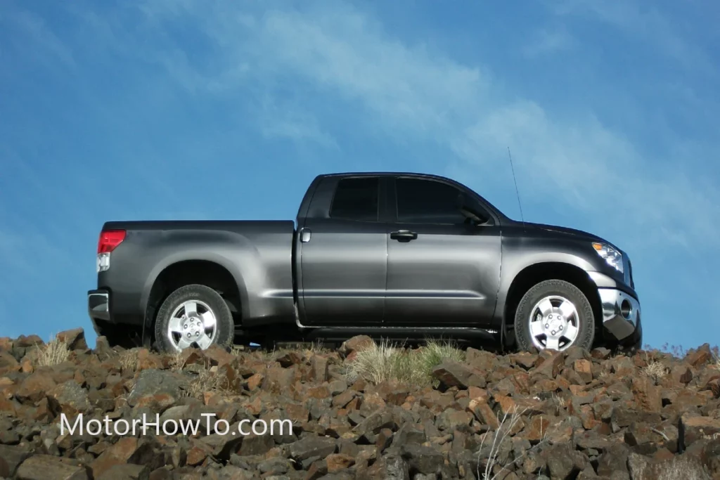 Gray pick-up truck parked in between rocks